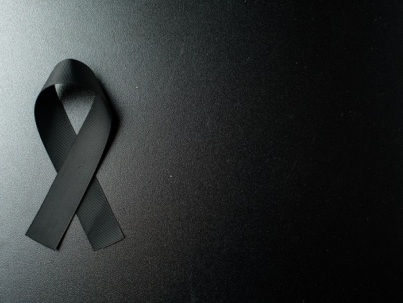 top view black bow as mourning symbol dark wall