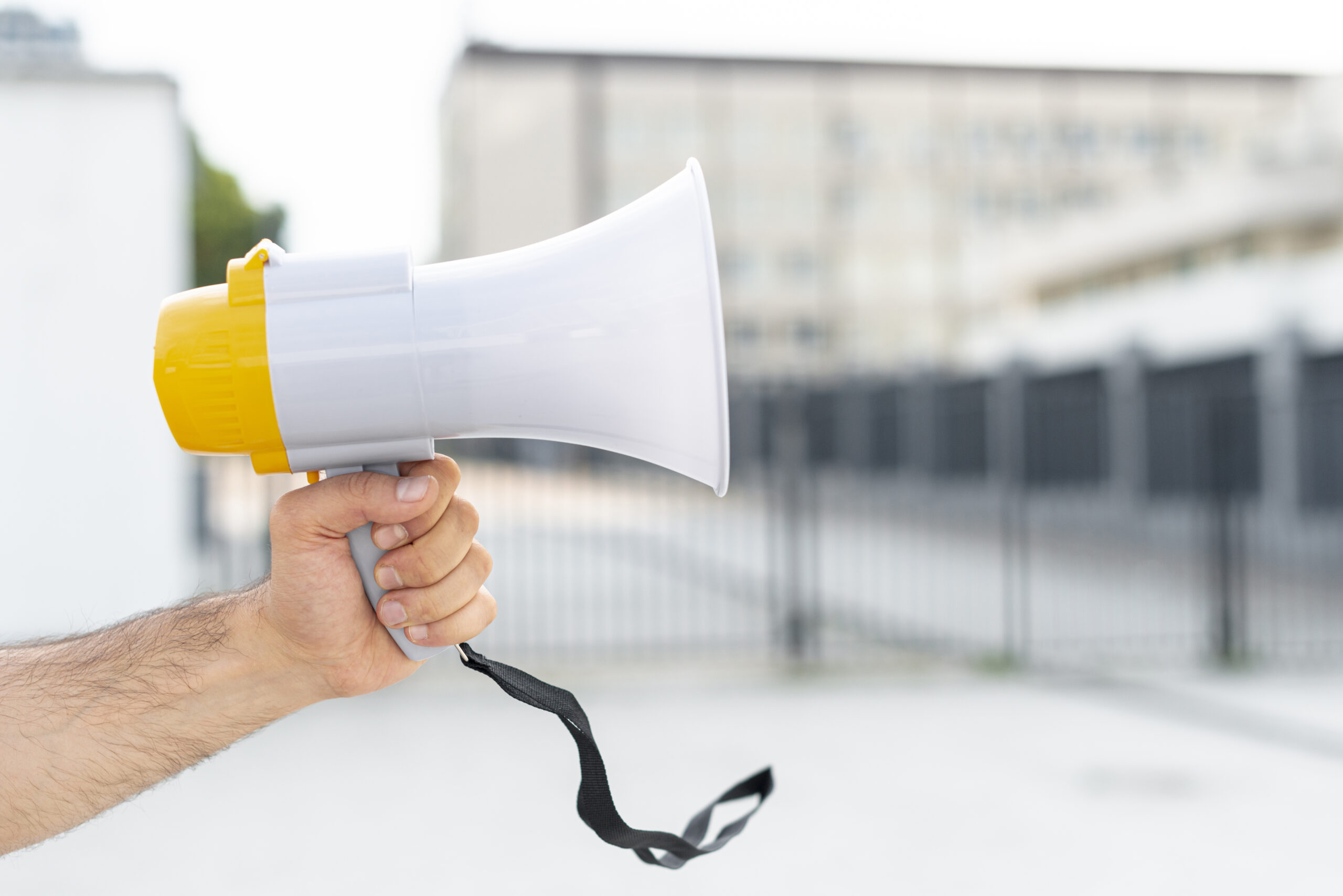 close-up-protester-holding-megaphone