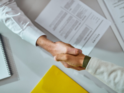 Close-up of businessmen shaking hands after successful agreement.